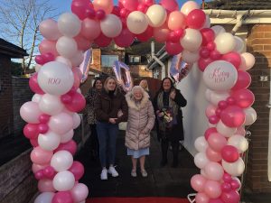 Melling resident Mary Burgess celebrating turning 100 on her doorstep in December 2020