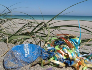 deflated balloon and decorative string on beach