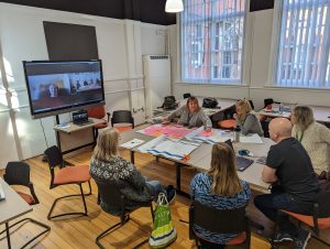 The Sandbrook co-production group sat around a table with floor plans and post-it notes.