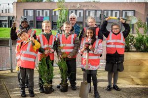 School children and volunteers gardening