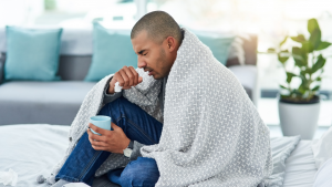 Person in a blanket sneezing